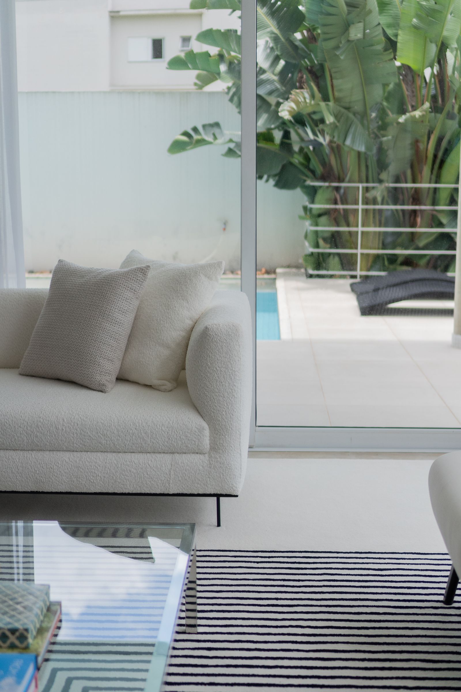 Low white linen sectional opening to a pool