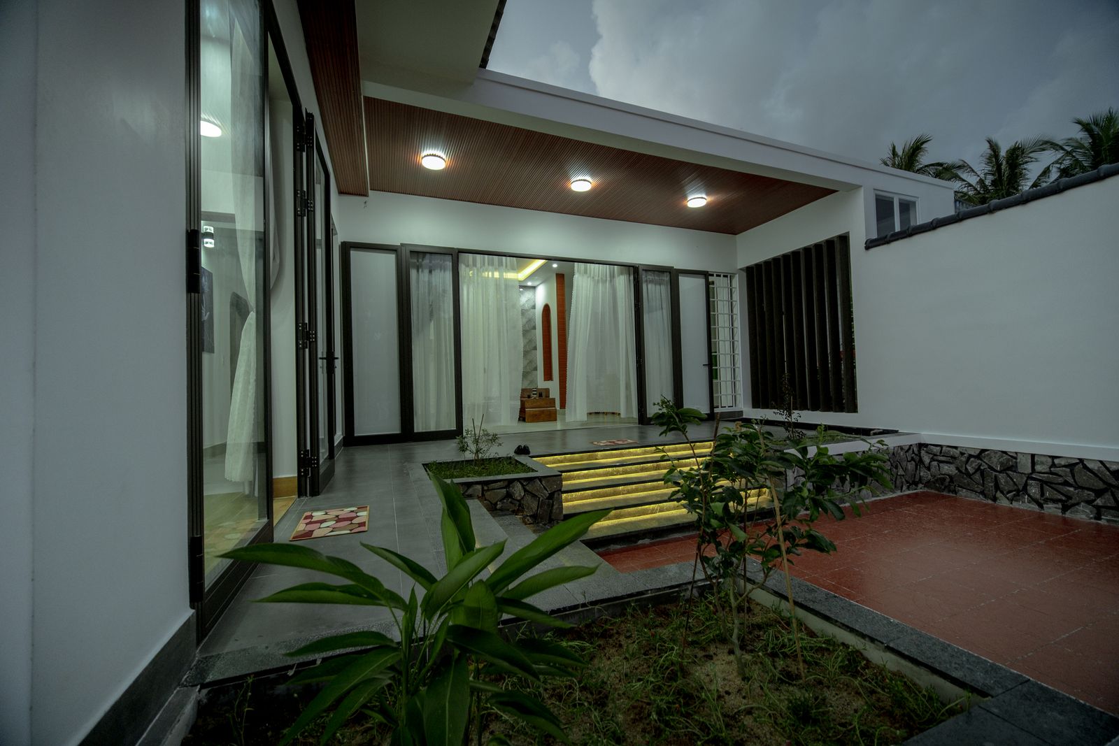 Villa entrance lit at evening