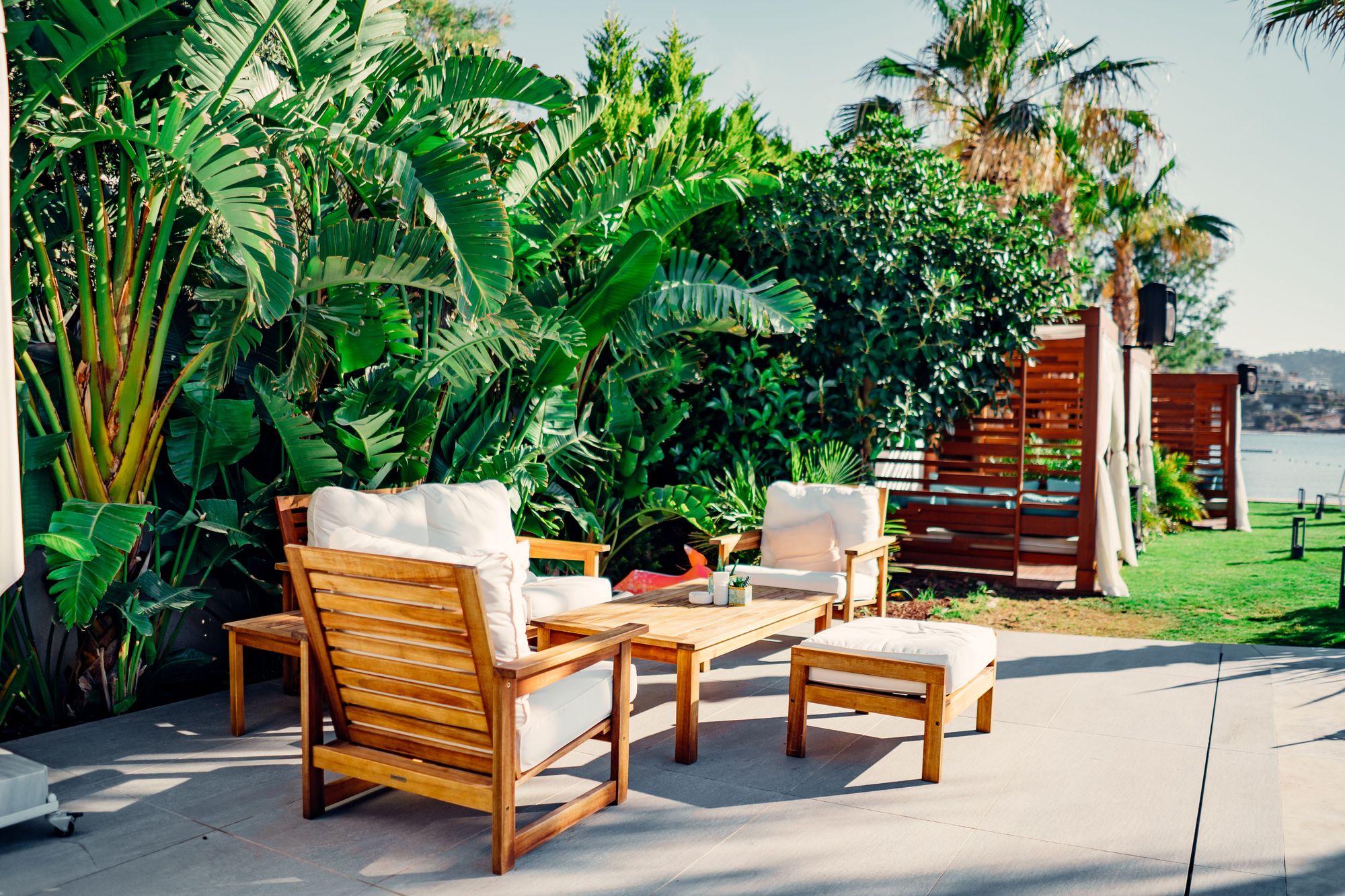 Teak outdoor sofa and armchairs on a garden patio