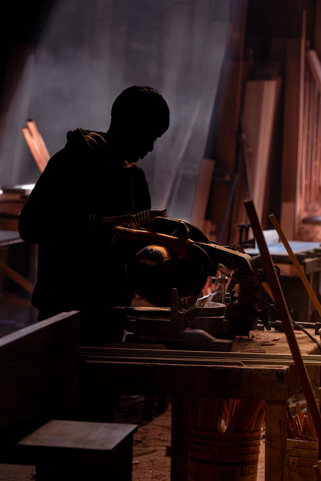 Woodworker cutting timber for a sofa frame