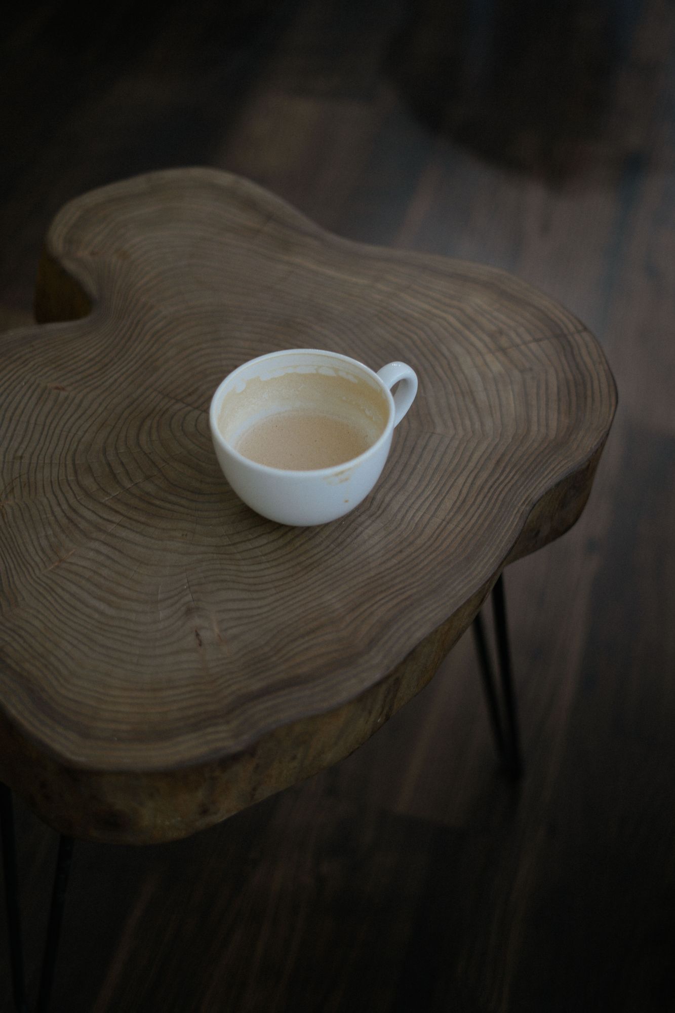 Live-edge wood slab side table with a cup of coffee
